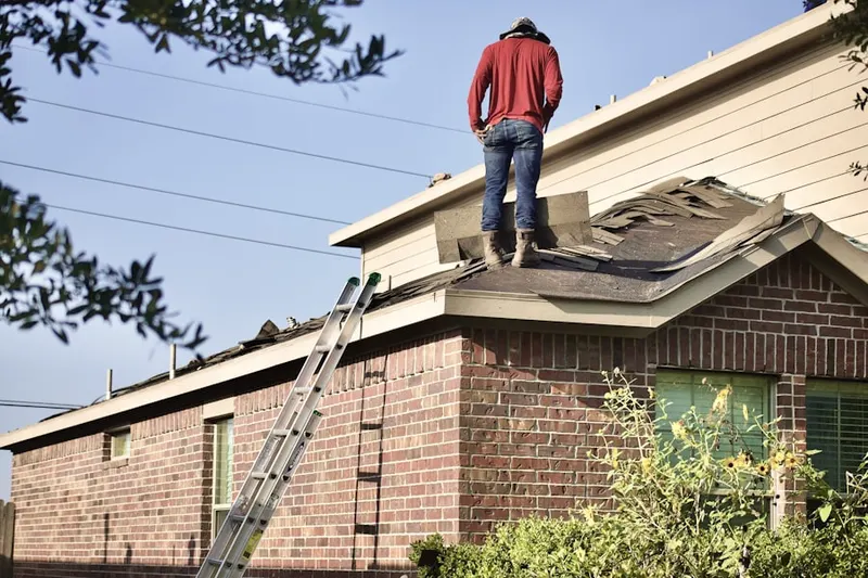 Professional roofer working on a residential roof in Williams Place